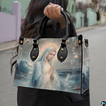 Street lifestyle view of woman carrying Stella Maris ocean wave handbag.