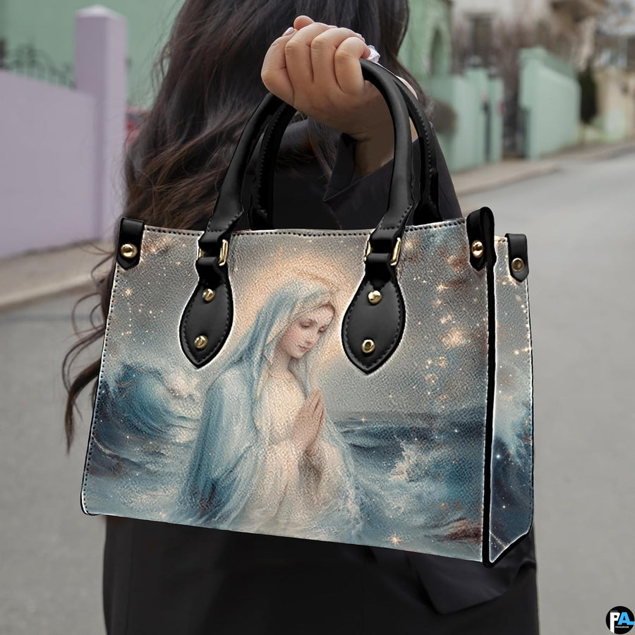 Street lifestyle view of woman carrying Stella Maris ocean wave handbag.