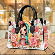 Chibi Virgin Mary handbag displayed on a wooden tabletop in front of a sunlit window.