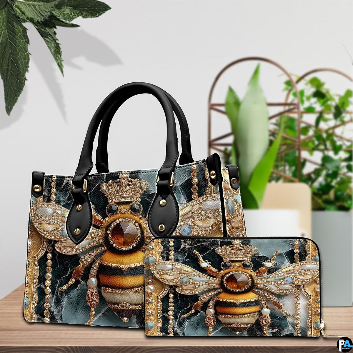 Coordinated arrangement of handbag and wallet showing the matching jeweled bee design.