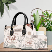 Christian Jesus handbag carried outdoors by top handle on residential street.