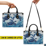Top-down view displaying interior compartment and handles of the sea turtle handbag.