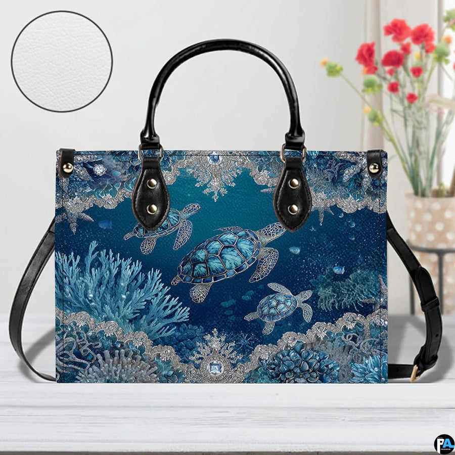 Perspective angle view of sea turtle handbag emphasizing decorative print and structured silhouette.