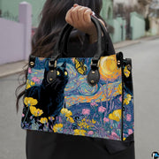 Van gogh starry night cat painting held outdoors along a sunny city walkway.