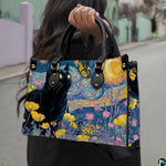 Van gogh starry night cat painting held outdoors along a sunny city walkway.
