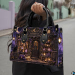 Witch apothecary handbag carried outdoors by top handle on residential street.