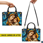 Model wearing stained glass Madonna handbag over shoulder with attached strap.