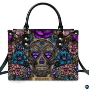 Gothic jeweled baroque skull floral handbag displayed alone on white studio background.