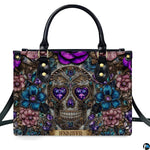 Gothic jeweled baroque skull floral handbag displayed alone on white studio background.