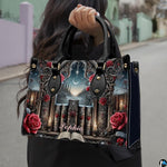 Gothic cathedral handbag carried outdoors by top handles displaying the intricate stone portal and rose artwork.