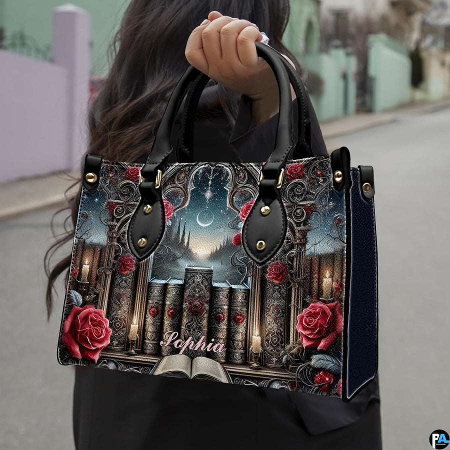 Gothic cathedral handbag carried outdoors by top handles displaying the intricate stone portal and rose artwork.