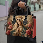 Angled view showing structured crowned Virgin Mary handbag
