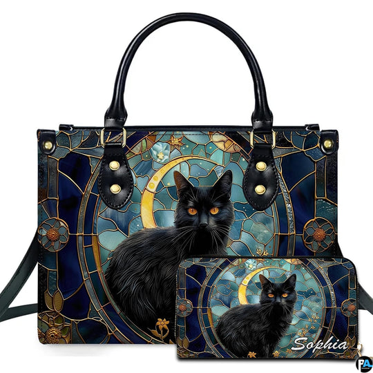 Ebony cat displaying amber eyes inside an ornate circular stained glass medallion beside a golden moon.