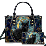Ebony cat displaying amber eyes inside an ornate circular stained glass medallion beside a golden moon.