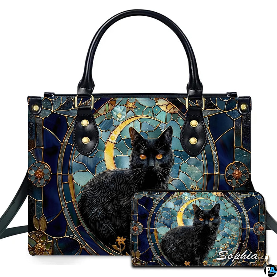 Ebony cat displaying amber eyes inside an ornate circular stained glass medallion beside a golden moon.