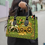 Model carrying leprechaun handbag with white horse artwork