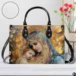 Virgin Mary and infant Jesus handbag displayed on white wooden table beside fresh floral bouquet