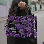 Front view of purple hydrangea butterfly cross handbag showing central floral butterfly and cross.