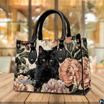 Presentation showing holding and shoulder carrying options for fluffy black cat art graphics.