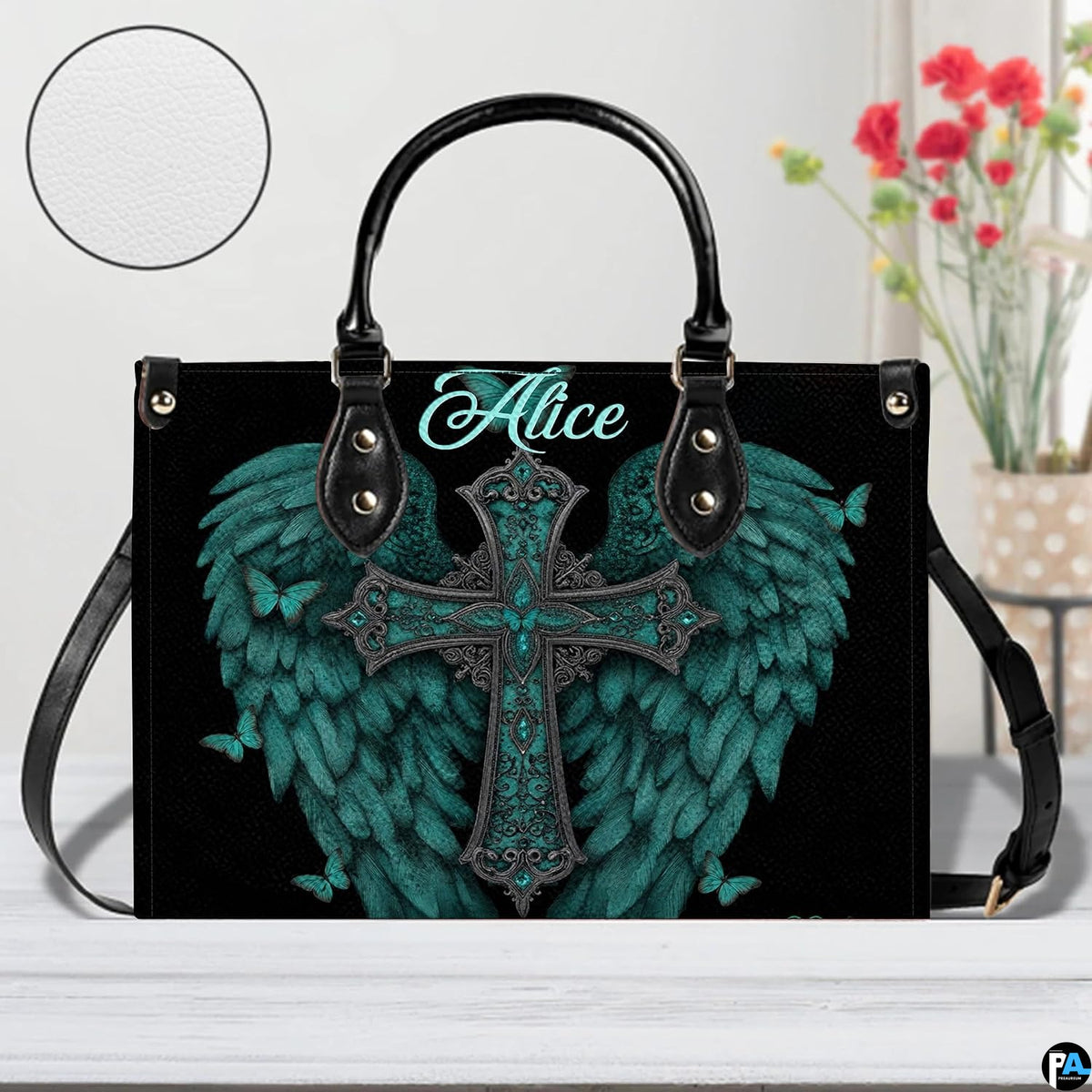 Side profile view of structured turquoise angel wings cross handbag.