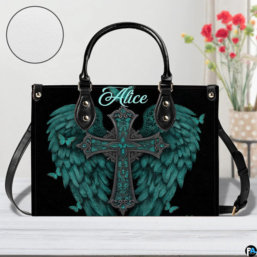 Side profile view of structured turquoise angel wings cross handbag.