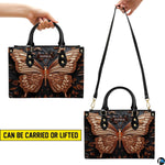 Handheld and shoulder carrying options demonstrated with the bronze butterfly handbag.